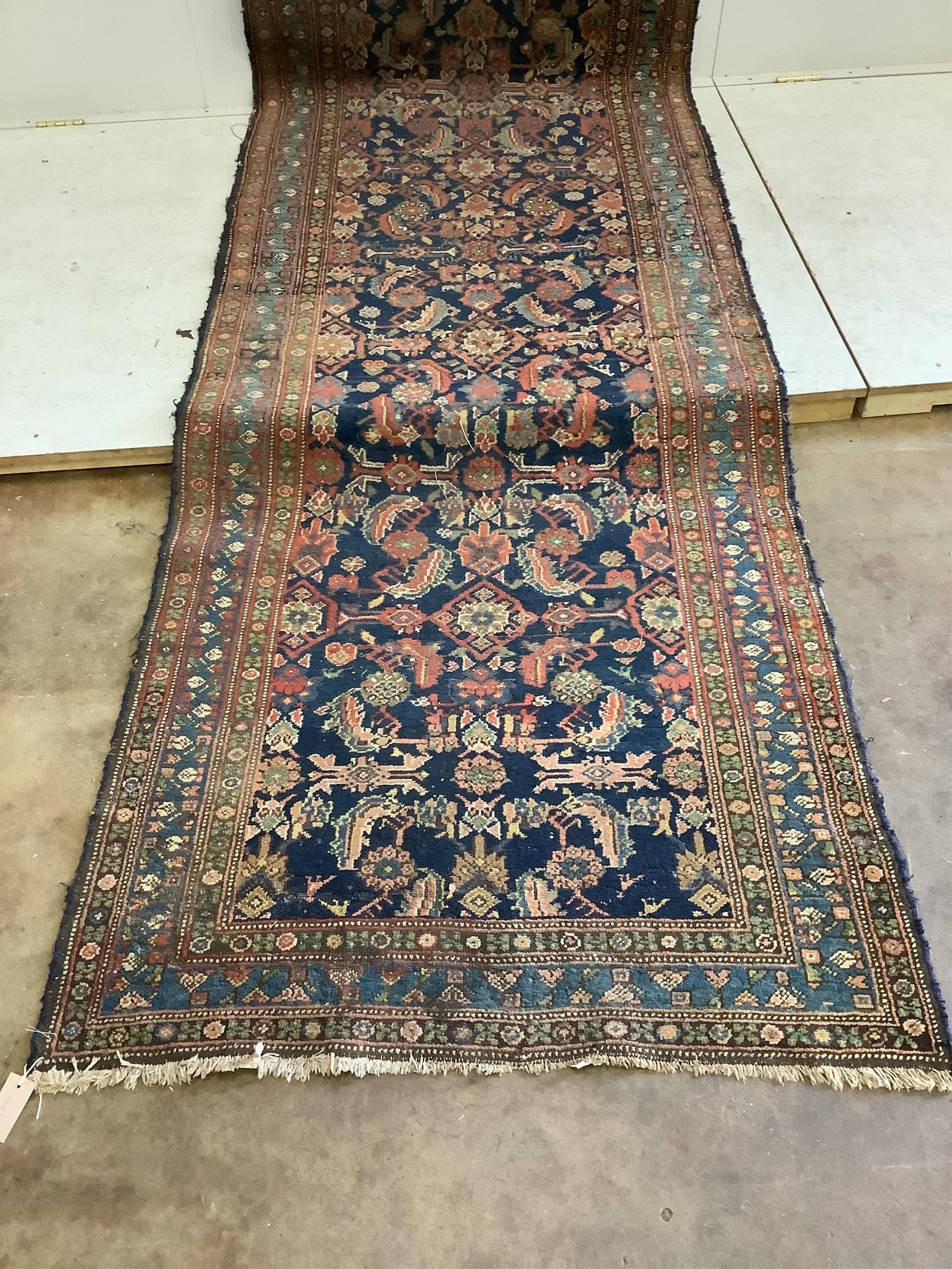An antique Hamadan blue ground runner, approximately 460 x 110cm. Condition - poor
